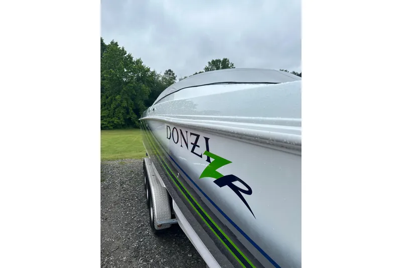 Slide: The Image of 2007 Donzi 35 ZR boat on trailer, side view with logo, outdoors. - 33