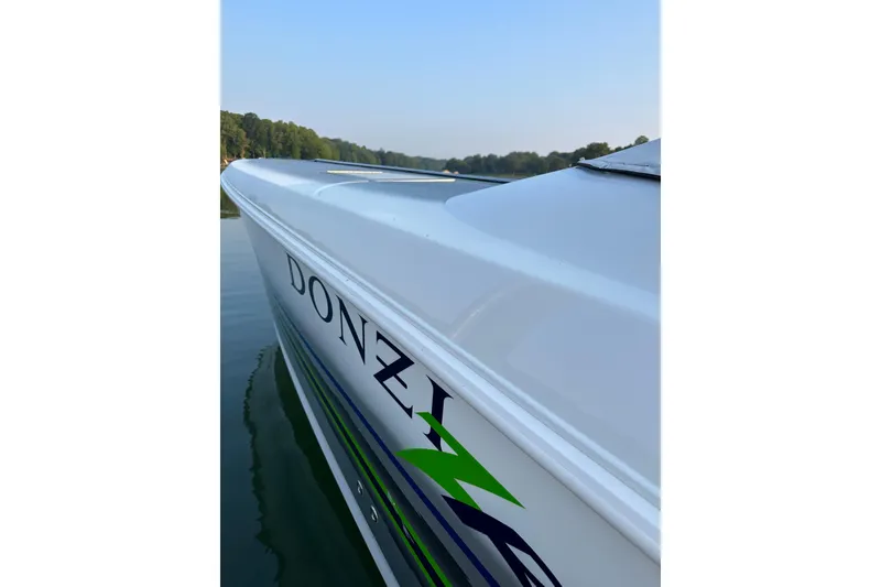 Slide: The Image of 2007 Donzi 35 ZR boat on calm water, showcasing sleek design and vibrant graphics. - 34