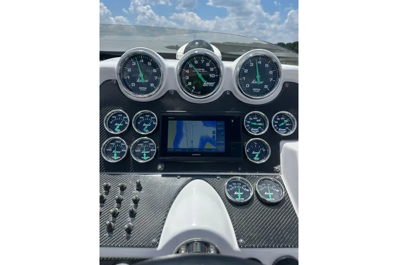 Slide: The Image of Dashboard of a 2007 Donzi 35 ZR boat with gauges and navigation display. - 35