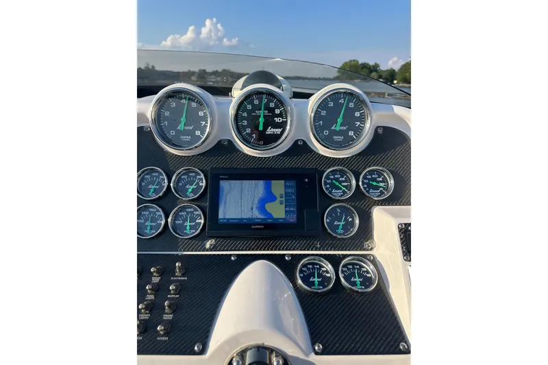 Slide: The Image of Dashboard of a 2007 Donzi 35 ZR boat with gauges and navigation display. - 36