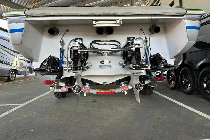 Slide: The Image of Rear view of a 2007 Donzi 35 ZR boat with dual propellers in a parking area. - 8