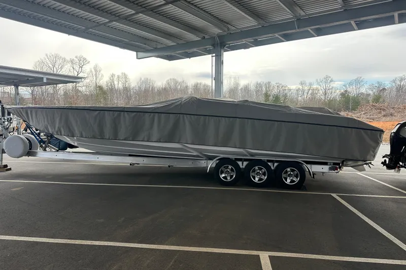 Slide: The Image of 2007 Donzi 35 ZR boat covered on a trailer under a shelter. - 9