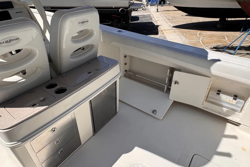 Slide: The Image of 2015 Sailfish 320 CC boat interior with storage compartments and seating. - 10