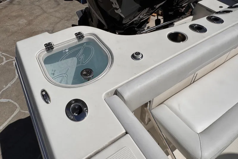 Slide: The Image of 2015 Sailfish 320 CC boat deck with seating and fishing rod holders. - 14