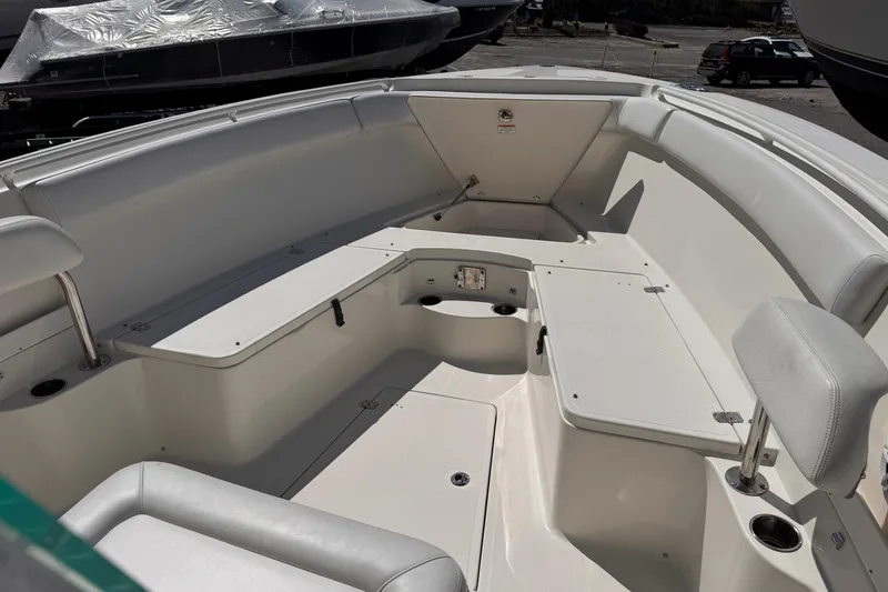 Slide: The Image of 2015 Sailfish 320 CC boat interior with spacious seating and storage compartments. - 15