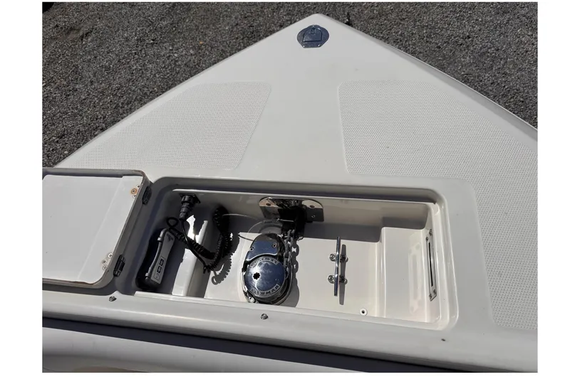 Slide: The Image of 2015 Sailfish 320 CC boat anchor compartment with winch and control panel. - 18