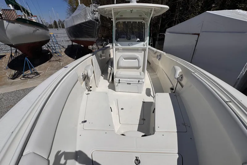 Slide: The Image of 2015 Sailfish 320 CC boat interior with seating and storage compartments. - 19