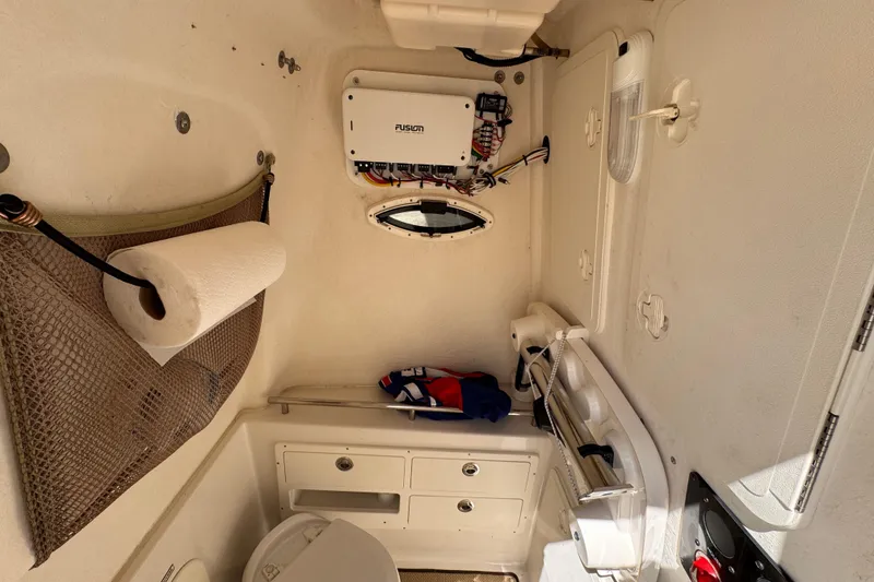 Slide: The Image of Interior of a 2015 Sailfish 320 CC boat featuring storage and equipment. - 22