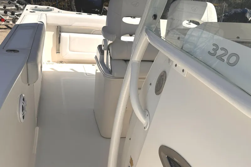 Slide: The Image of 2015 Sailfish 320 CC boat interior with seating and console details. - 24