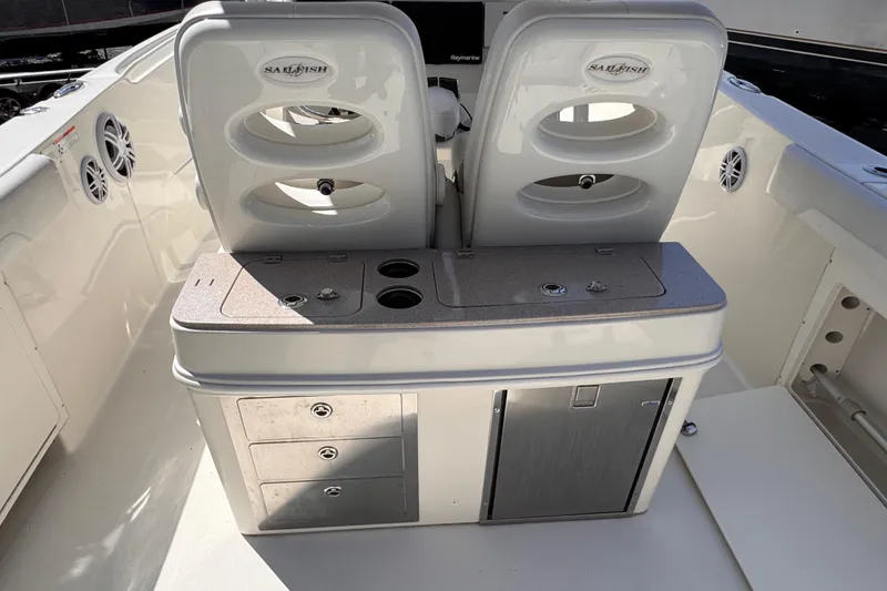 Slide: The Image of 2015 Sailfish 320 CC boat interior with dual seats and storage compartments. - 28