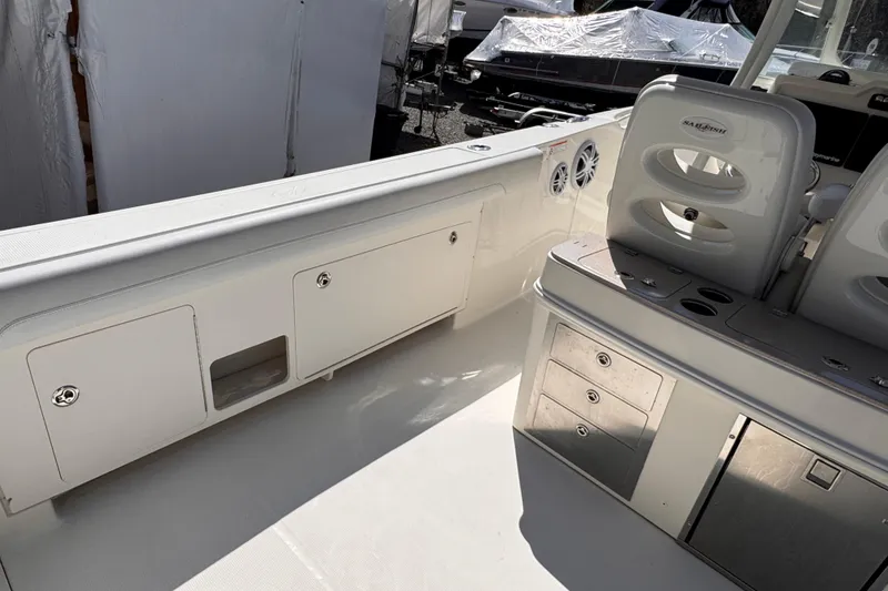 Slide: The Image of Interior view of a 2015 Sailfish 320 CC boat, featuring storage compartments and seating. - 29