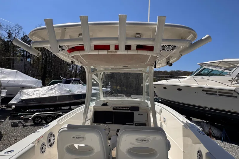 Slide: The Image of 2015 Sailfish 320 CC boat interior with T-top and dual helm seats. - 3