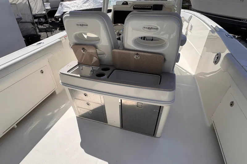 Slide: The Image of 2015 Sailfish 320 CC boat interior with seating and storage compartments. - 30