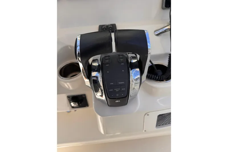 Slide: The Image of Throttle controls on a 2015 Sailfish 320 CC boat dashboard. - 31