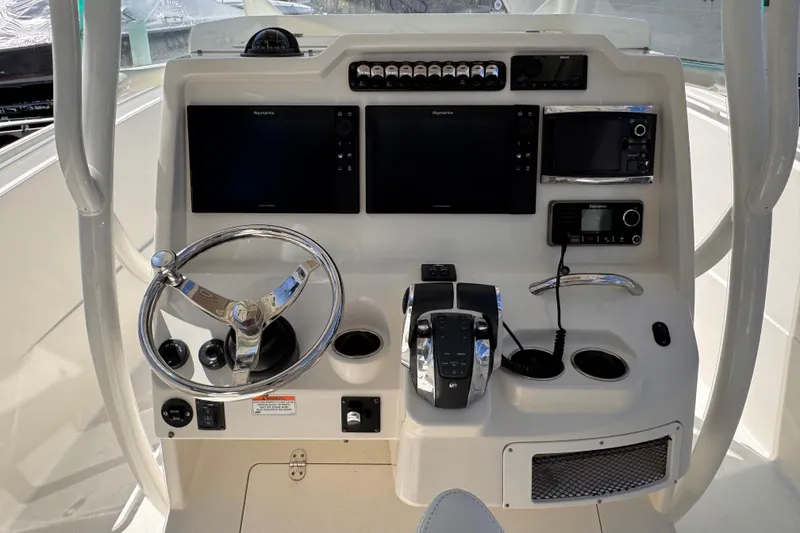Slide: The Image of Control panel of a 2015 Sailfish 320 CC boat with steering wheel and navigation screens. - 5