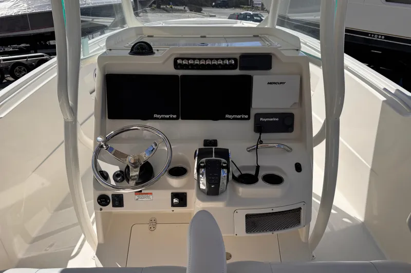 Slide: The Image of 2015 Sailfish 320 CC boat dashboard with steering wheel and navigation controls. - 6