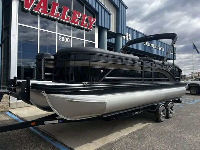 Slide: The Image of Bennington 23SSB LUXE 2026 pontoon boat parked outside a building. - 2