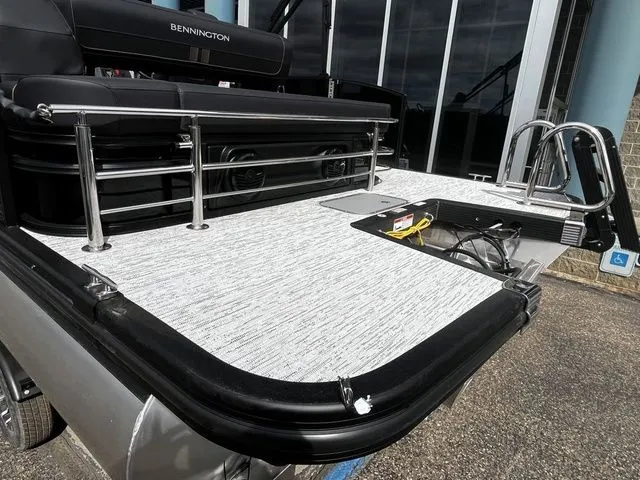 Slide: The Image of 2026 Bennington 23SSB LUXE pontoon boat rear view with platform and ladder. - 4