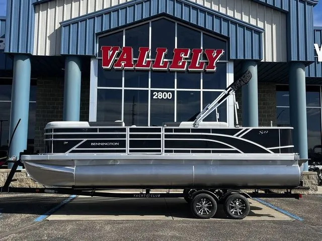 The Image of 2026 Bennington 22SFC S-One pontoon boat in front of a building. - 1