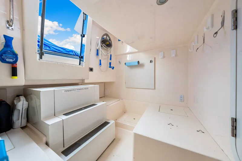 Slide: The Image of 2007 Marquis 59 Markham Edition yacht interior with storage and equipment, featuring open hatch and hooks. - 101