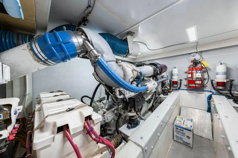 Slide: The Image of Engine room of 2007 Marquis 59 Markham Edition yacht, featuring mechanical components and fire safety equipment. - 104