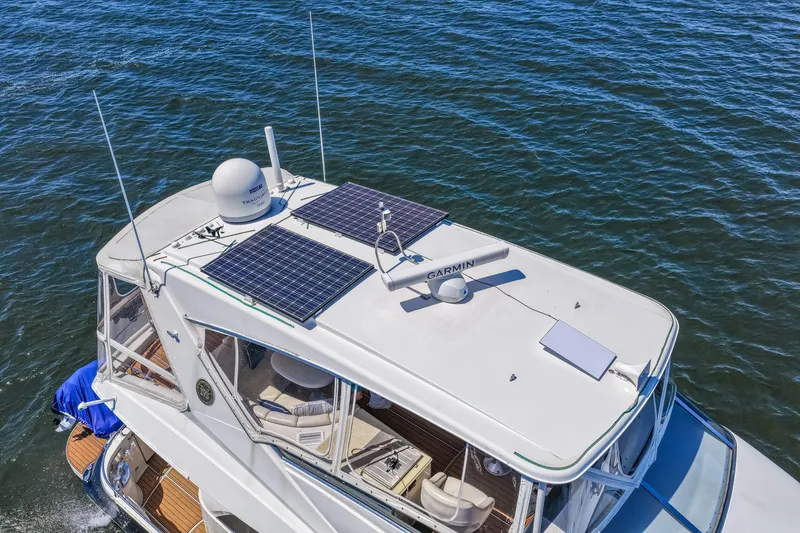 Slide: The Image of 2007 Marquis 59 Markham Edition yacht with solar panels on the roof, cruising on water. - 12