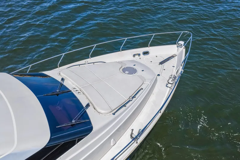 Slide: The Image of Luxury yacht Marquis 59 Markham Edition 2007 on open water, showcasing sleek design and spacious deck. - 13