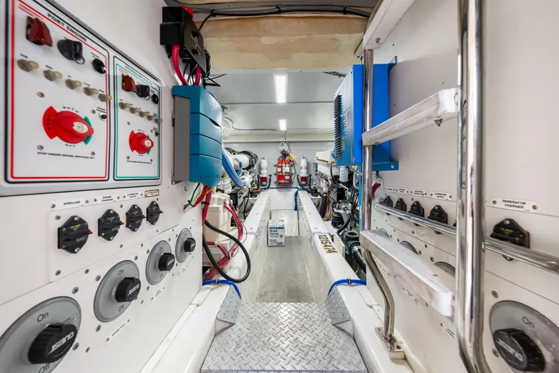 Slide: The Image of Engine room of 2007 Marquis 59 Markham Edition yacht with control panels and equipment. - 198