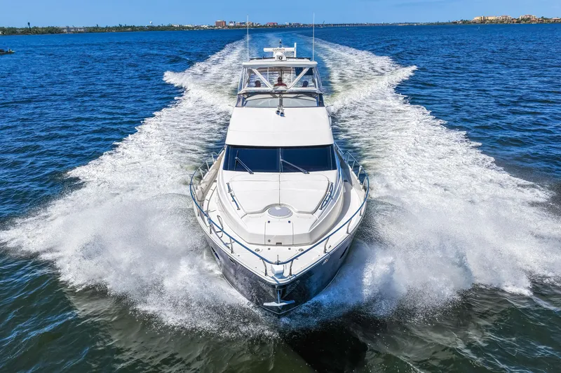 Slide: The Image of 2007 Marquis 59 Markham Edition yacht cruising on open water, creating a dynamic wake. - 33