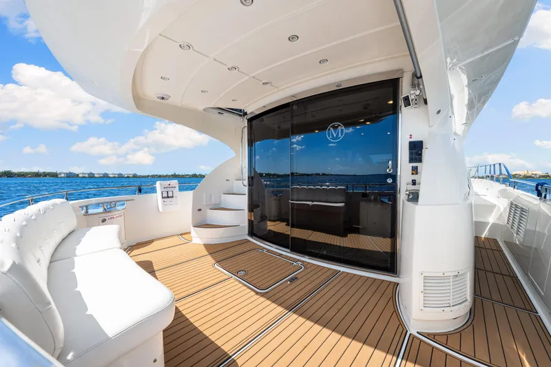 Slide: The Image of Luxurious 2007 Marquis 59 Markham Edition yacht deck with elegant seating and ocean view. - 49