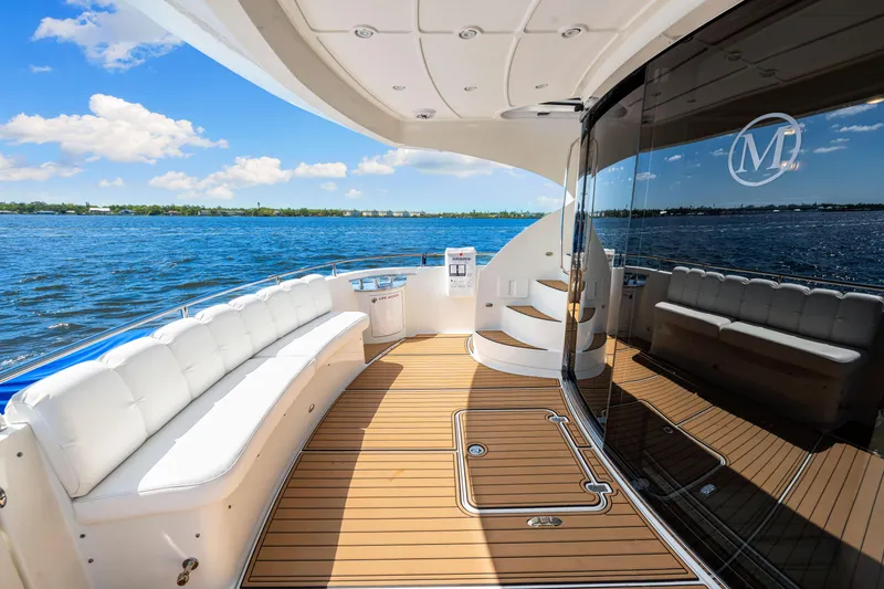 Slide: The Image of Luxurious 2007 Marquis 59 Markham Edition yacht deck with elegant seating and scenic water view. - 51