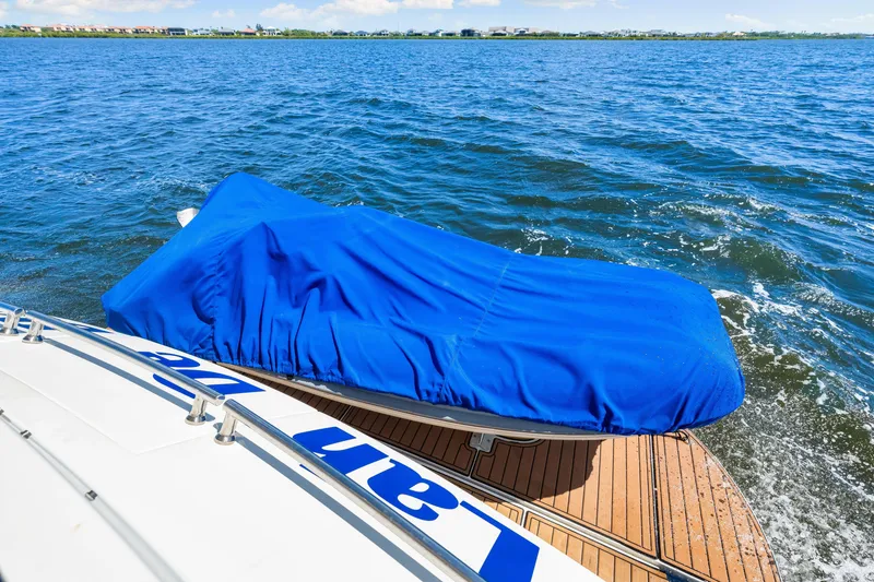 Slide: The Image of Luxury yacht Marquis 59 Markham Edition, 2007, with blue-covered deck, cruising on open water. - 54