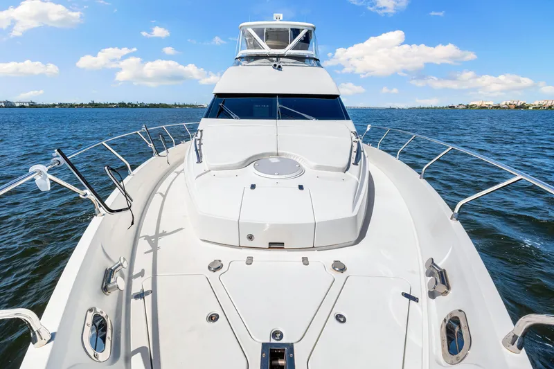Slide: The Image of Luxury yacht Marquis 59 Markham Edition 2007 cruising on open water under blue skies. - 58