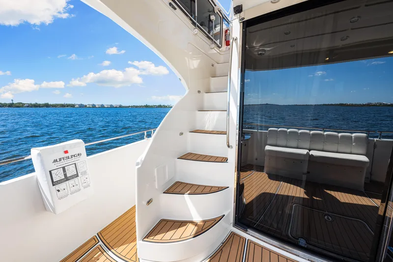 Slide: The Image of Luxurious 2007 Marquis 59 Markham Edition yacht interior with elegant staircase and scenic ocean view. - 61