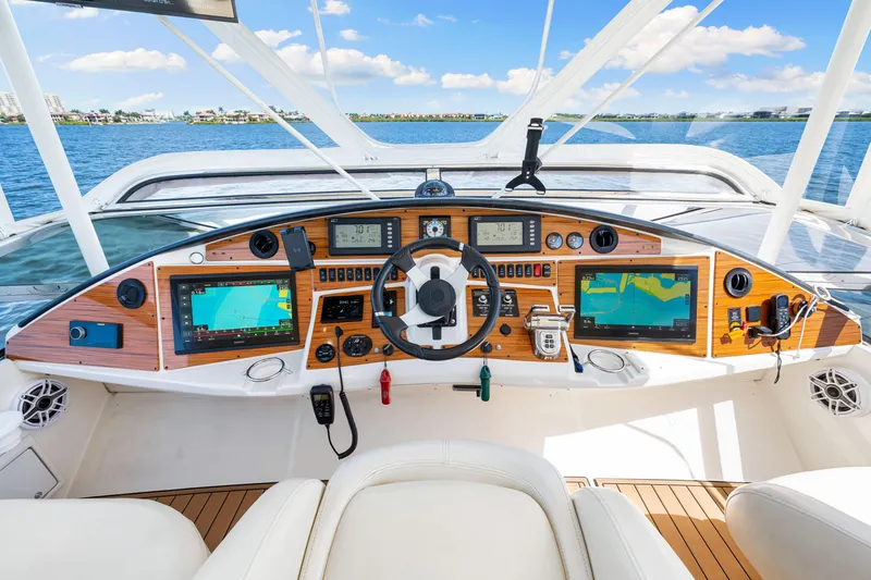 Slide: The Image of Luxurious 2007 Marquis 59 Markham Edition yacht helm with advanced navigation systems and scenic ocean view. - 72