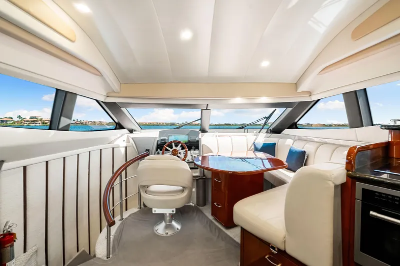 Slide: The Image of Luxurious interior of 2007 Marquis 59 Markham Edition yacht with elegant seating and panoramic windows. - 84