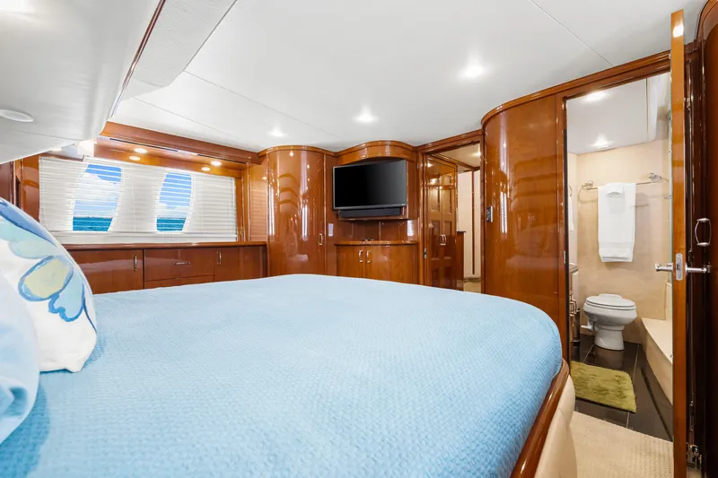 Slide: The Image of Luxurious 2007 Marquis 59 Markham Edition yacht bedroom with ensuite bathroom and elegant wood finishes. - 93