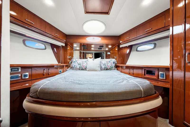 Slide: The Image of Luxurious 2007 Marquis 59 Markham Edition yacht bedroom with elegant wood finish and plush bedding. - 96