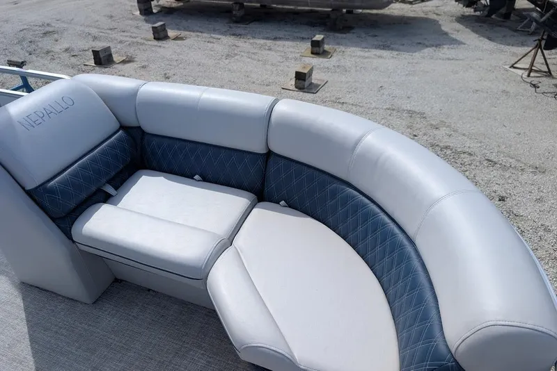 Slide: The Image of Luxurious Nepallo 22QL 2022 boat seating with blue and white upholstery, outdoor setting. - 10
