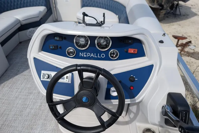 Slide: The Image of Steering console of a 2022 Nepallo 22QL boat with gauges and controls. - 13