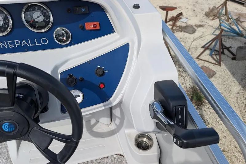 Slide: The Image of Control panel of a 2022 Nepallo 22QL boat with steering wheel and throttle lever. - 15