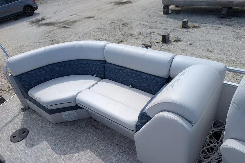 Slide: The Image of 2022 Nepallo 22QL pontoon boat with cushioned seating, parked on gravel surface. - 17