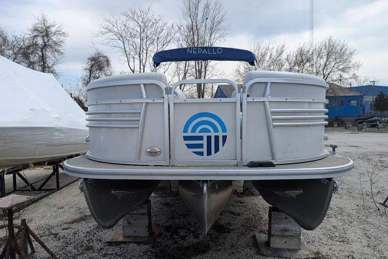 Slide: The Image of 2022 Nepallo 22QL pontoon boat on stands, featuring a blue logo and canopy. - 6