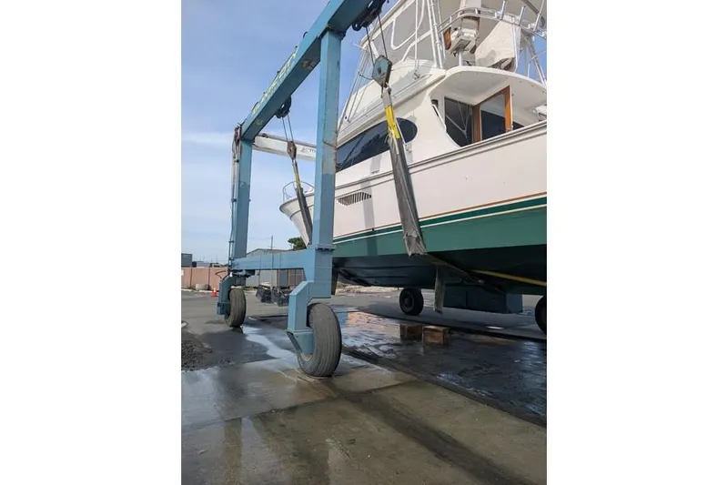 Slide: The Image of 2005 Egg Harbor 43 SportYacht on a boat lift at a marina. - 10