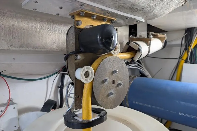 Slide: The Image of Engine room detail of a 2005 Egg Harbor 43 SportYacht, showcasing mechanical components and wiring. - 111