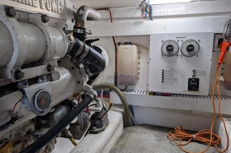 Slide: The Image of Engine room of a 2005 Egg Harbor 43 SportYacht with visible machinery and control panels. - 112