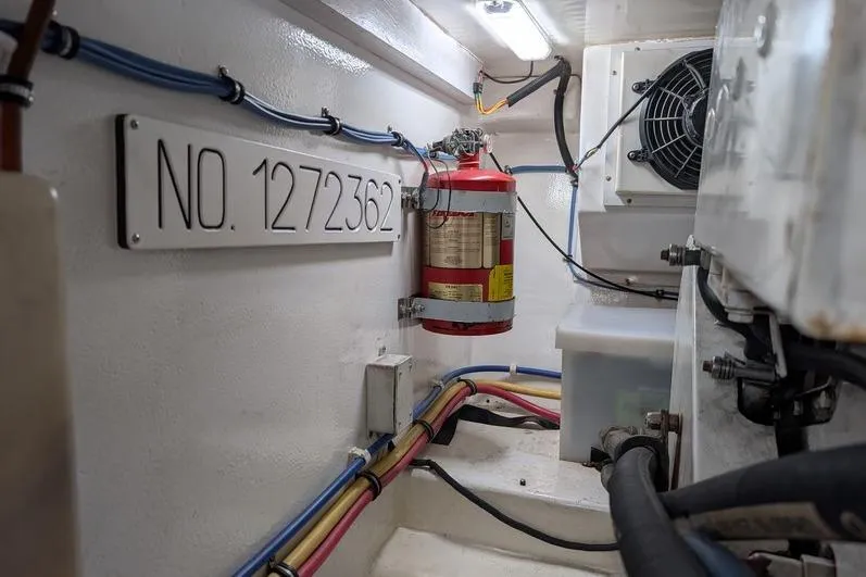 Slide: The Image of Engine room of 2005 Egg Harbor 43 SportYacht with fire extinguisher and wiring. - 113