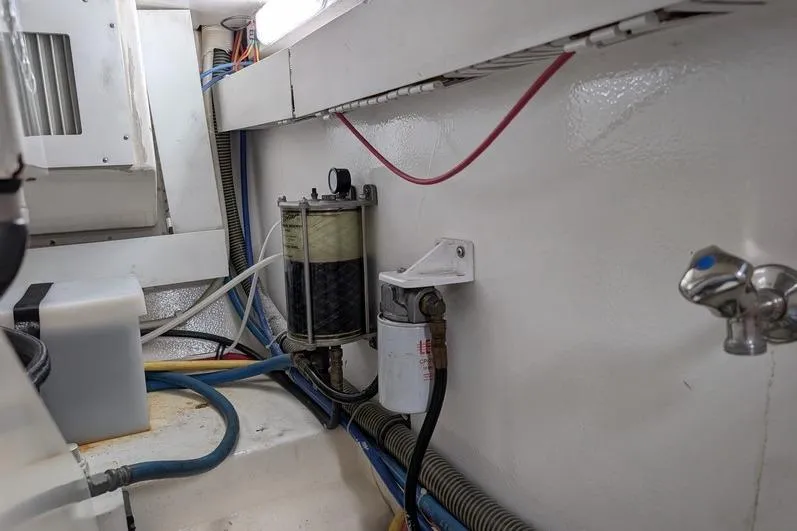 Slide: The Image of Engine room of 2005 Egg Harbor 43 SportYacht with fuel filters and wiring. - 114