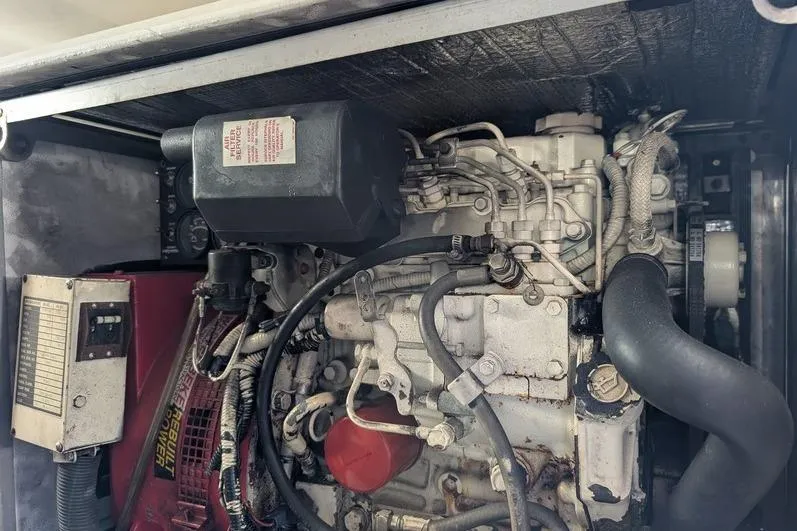 Slide: The Image of Engine compartment of a 2005 Egg Harbor 43 SportYacht, showcasing mechanical components and wiring. - 118