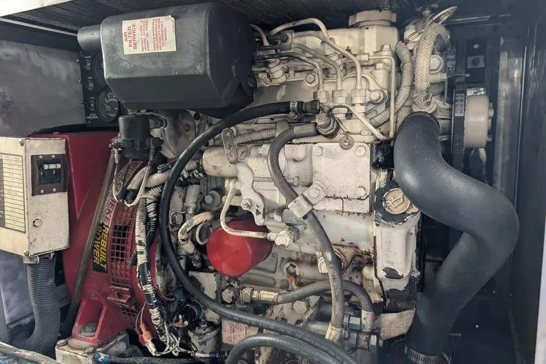 Slide: The Image of Engine compartment of a 2005 Egg Harbor 43 SportYacht, showcasing mechanical components and wiring. - 119